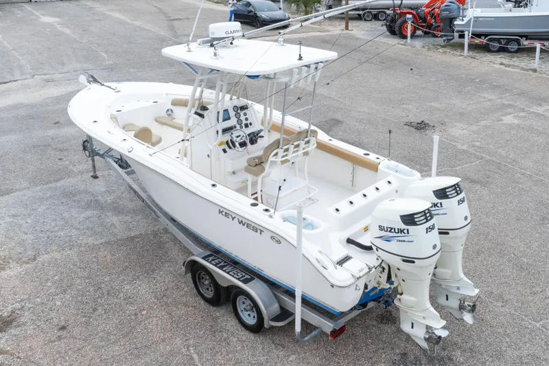 Slide: The Image of 2016 Key West 244 Center Console boat with twin Suzuki 150 engines on trailer. - 34