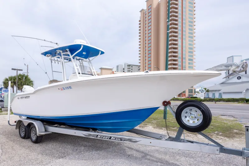 Slide: The Image of 2016 Key West 244 Center Console boat on trailer, urban background. - 5