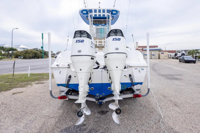 Slide: The Image of 2016 Key West 244 Center Console boat with dual 150 horsepower engines, parked on a lot. - 6