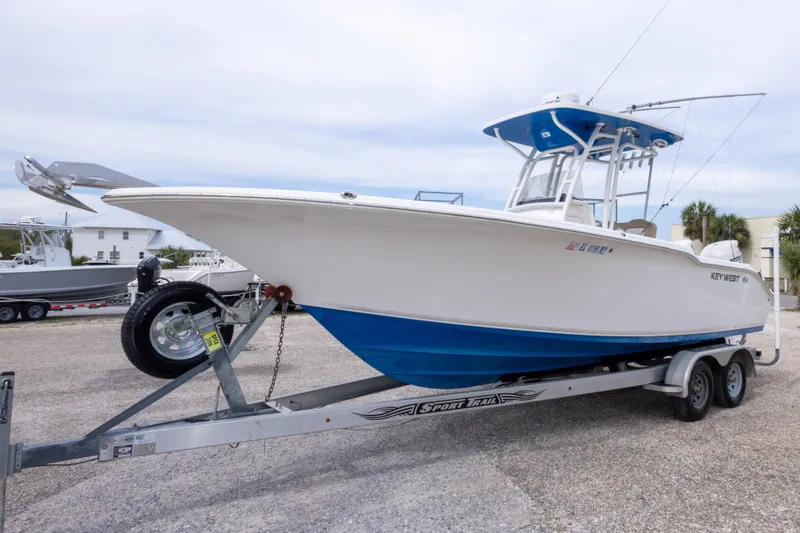Slide: The Image of 2016 Key West 244 Center Console boat on trailer, parked outdoors. - 9