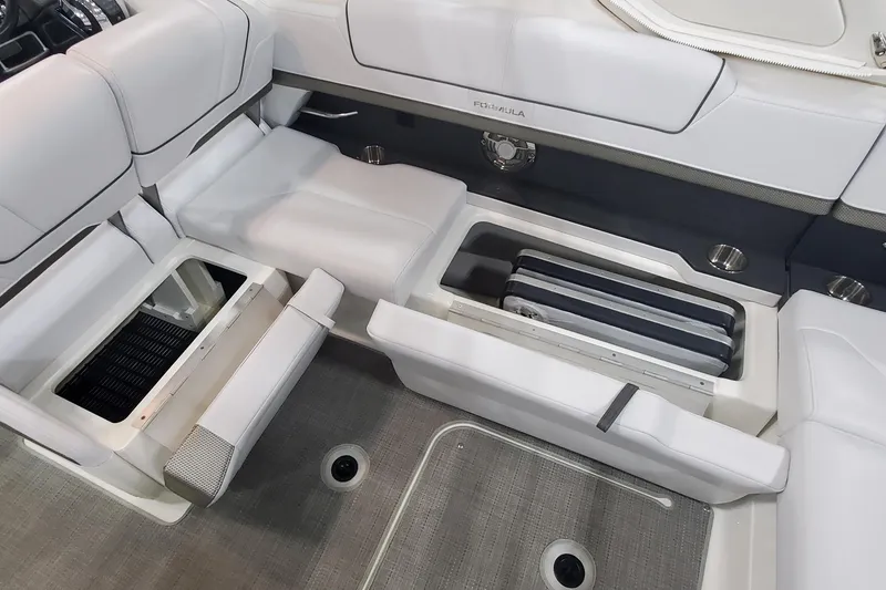 Slide: The Image of 2017 Formula 310 Bowrider interior seating with storage compartments open. - 11