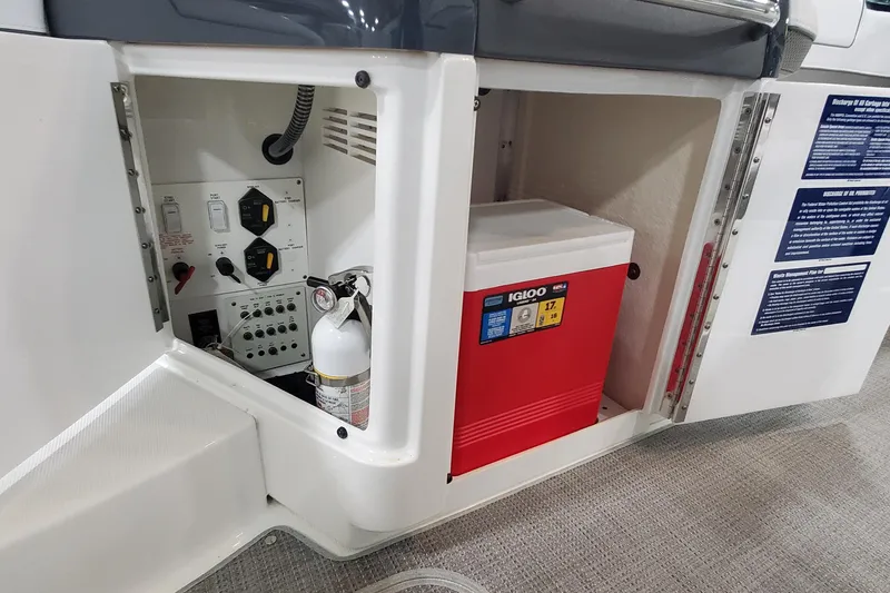 Slide: The Image of 2017 Formula 310 Bowrider storage compartment with cooler and fire extinguisher. - 17