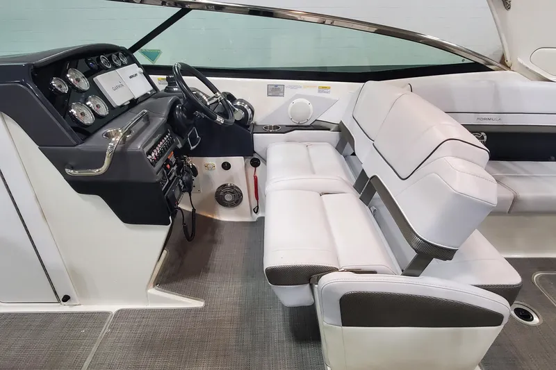 Slide: The Image of Interior of a 2017 Formula 310 Bowrider boat with white seating and control panel. - 19