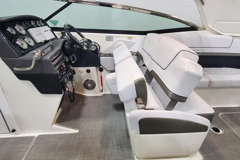 Slide: The Image of Interior of a 2017 Formula 310 Bowrider boat with white seating and control panel. - 20