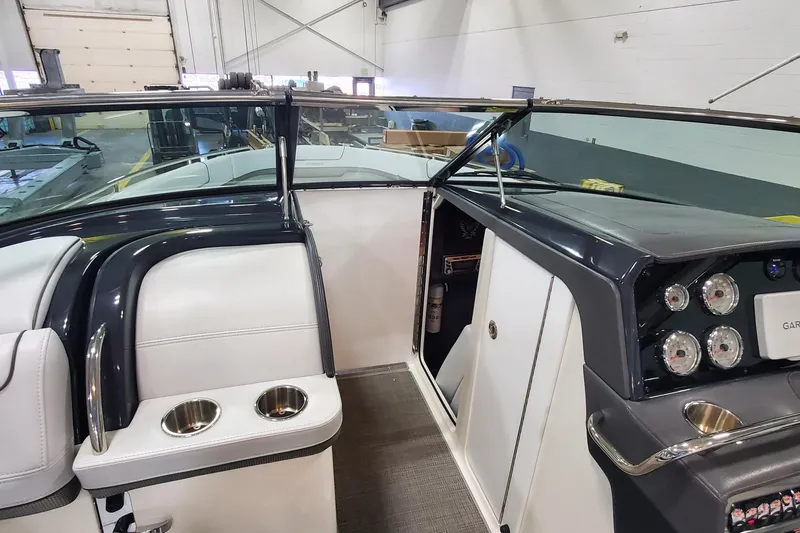 Slide: The Image of 2017 Formula 310 Bowrider interior with dashboard and seating area in a showroom. - 25
