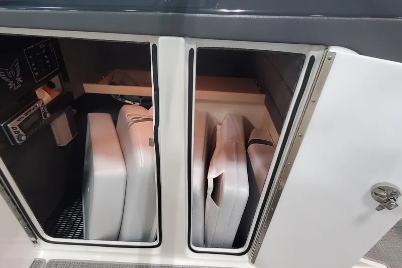 Slide: The Image of Storage compartment in 2017 Formula 310 Bowrider boat with cushions and equipment. - 26