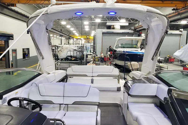 Slide: The Image of 2017 Formula 310 Bowrider interior in a workshop setting, showcasing seating and helm. - 34