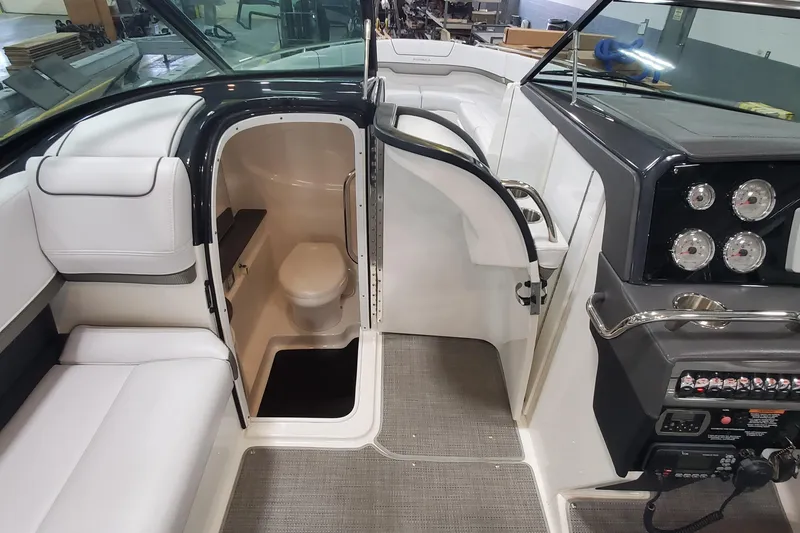 Slide: The Image of Interior of 2017 Formula 310 Bowrider boat showing seating, helm, and cabin with toilet. - 36