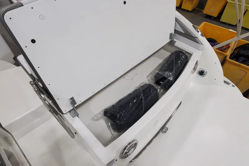 Slide: The Image of 2017 Formula 310 Bowrider storage compartment with wrapped items inside. - 7