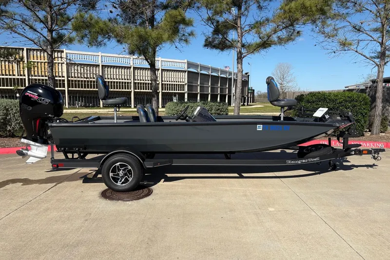 Slide: The Image of 2024 Ranger RT198P fishing boat on trailer, parked outdoors. - 2