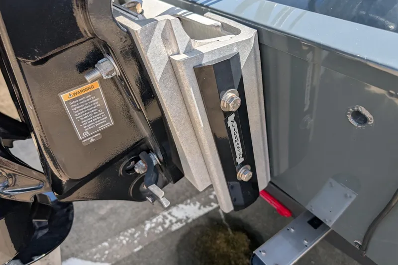 Slide: The Image of 2024 Ranger RT198P boat detail showing a SlideMaster jack plate and warning label. - 13