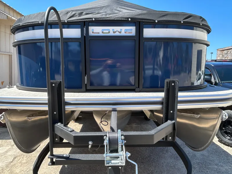 Slide: The Image of 2025 Lowe LS210WT pontoon boat on trailer, front view with cover. - 8