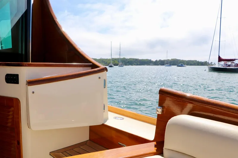 Slide: The Image of Hinckley Talaria 48 MKII yacht interior with scenic water view, 2026 model. - 11