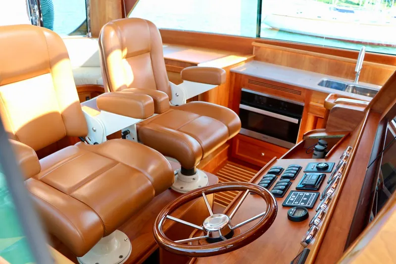 Slide: The Image of Luxurious interior of 2026 Hinckley Talaria 48 MKII yacht with leather seating and modern controls. - 13