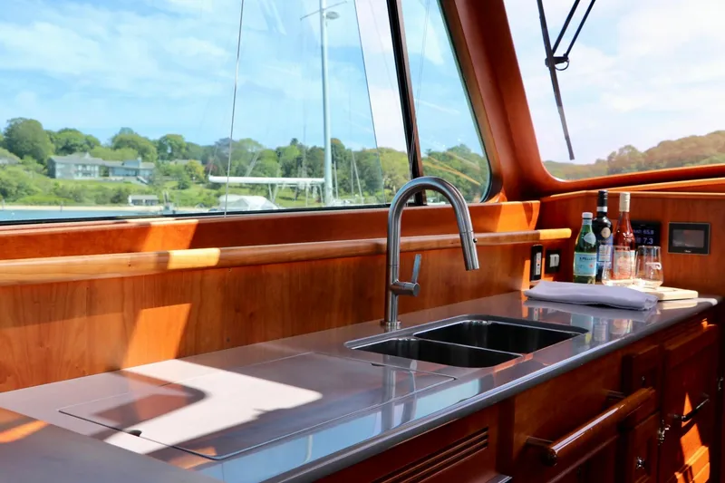 Slide: The Image of Luxurious interior of 2026 Hinckley Talaria 48 MKII yacht with sleek kitchen area. - 16