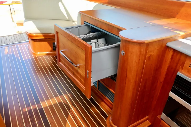 Slide: The Image of Interior of 2026 Hinckley Talaria 48 MKII yacht with open wooden cabinet drawer. - 17