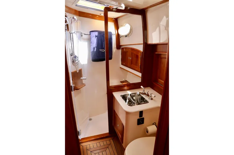 Slide: The Image of Luxurious bathroom in 2026 Hinckley Talaria 48 MKII yacht with wood accents and modern fixtures. - 21