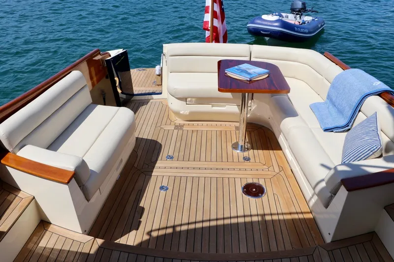Slide: The Image of Hinckley Talaria 48 MKII 2026 yacht deck with luxurious seating and wooden flooring. - 3