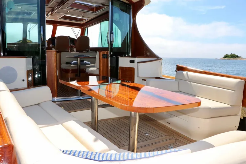 Slide: The Image of Luxurious interior of 2026 Hinckley Talaria 48 MKII yacht with elegant seating and wooden table. - 4