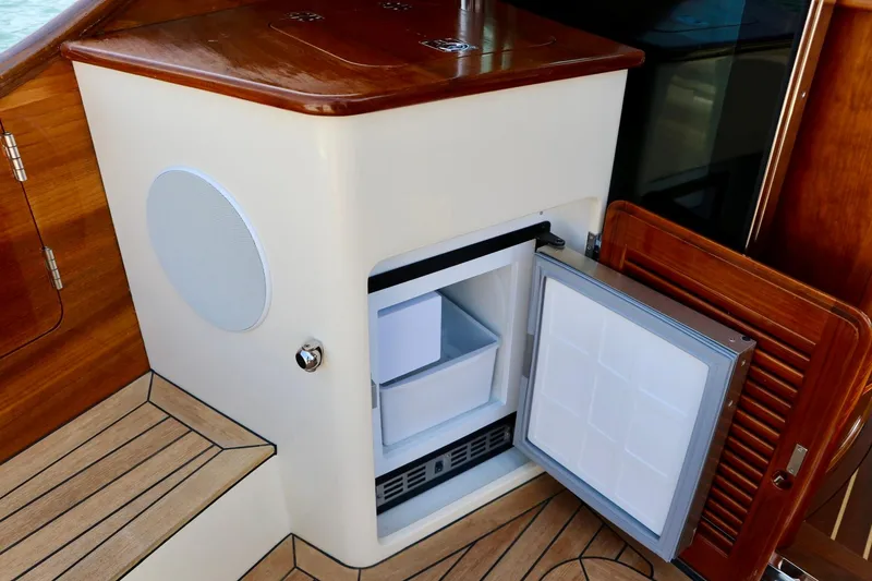 Slide: The Image of Open mini fridge on 2026 Hinckley Talaria 48 MKII yacht with wooden interior. - 9