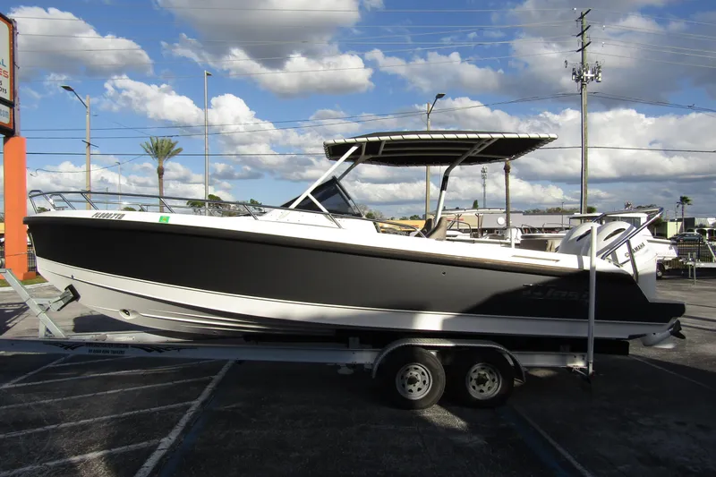 The Image of 2023 Windy SR28 CC boat on trailer under cloudy sky. - 0