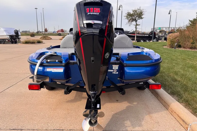Slide: The Image of Blue Nitro Z17 boat with Mercury 115 Pro XS engine, parked on pavement. - 1