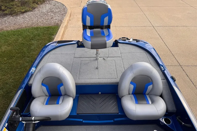 Slide: The Image of 2026 Nitro Z17 boat interior with gray and blue seating on a concrete surface. - 7