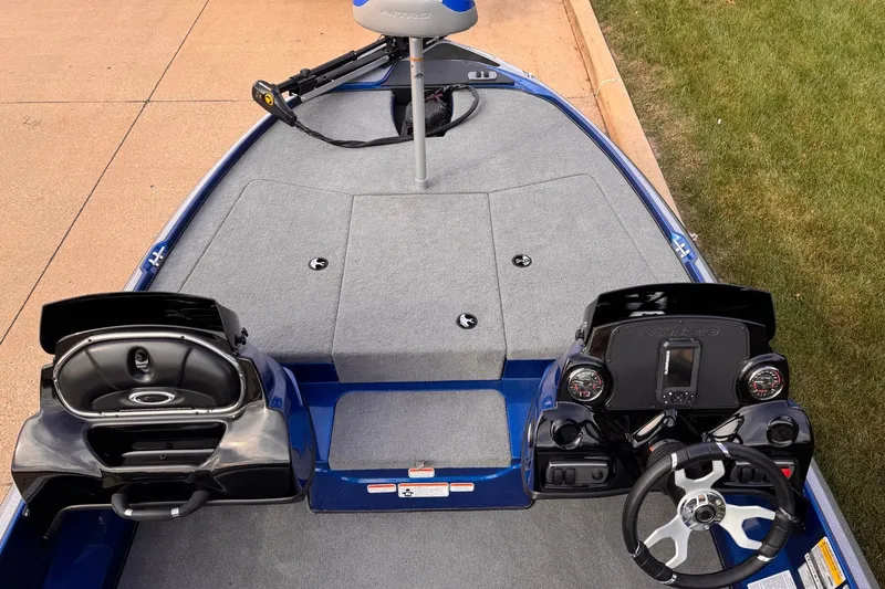 Slide: The Image of 2026 Nitro Z17 boat interior with dual consoles and steering wheel, parked on pavement. - 4