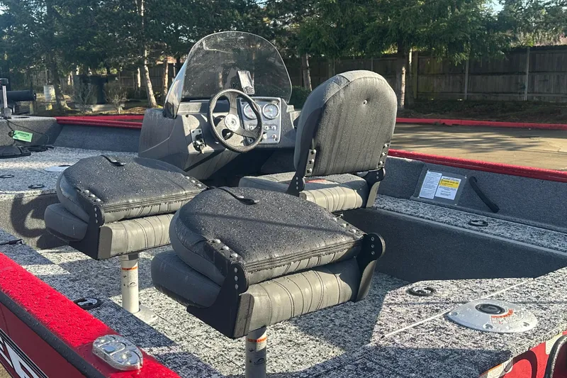 Slide: The Image of 2026 Tracker Pro Guide V-16 SC boat interior with dual seats and steering console. - 3