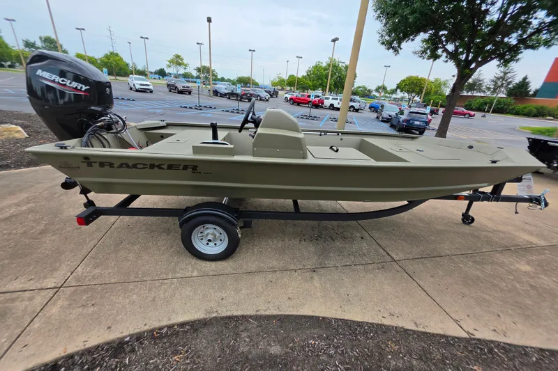 The Image of 2026 Tracker Grizzly 1648 SC boat on trailer in parking lot. - 0
