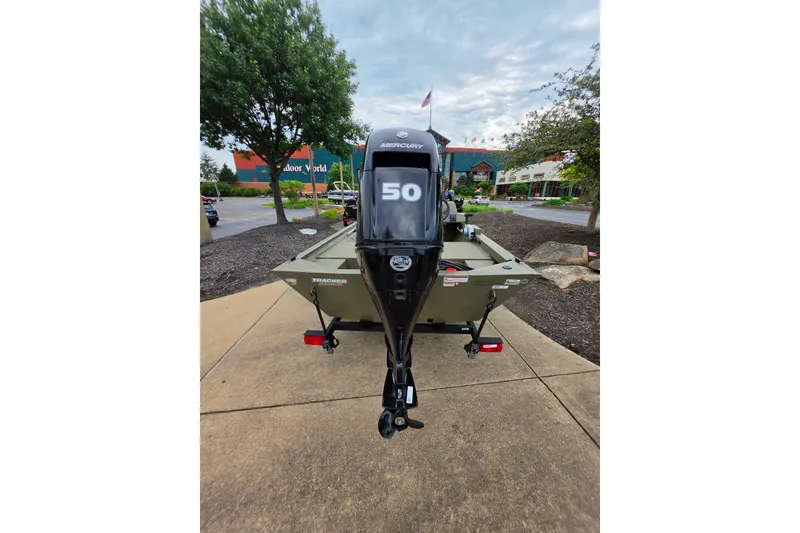 Slide: The Image of 2026 Tracker Grizzly 1648 SC boat with Mercury 50 outboard motor, parked outdoors. - 3