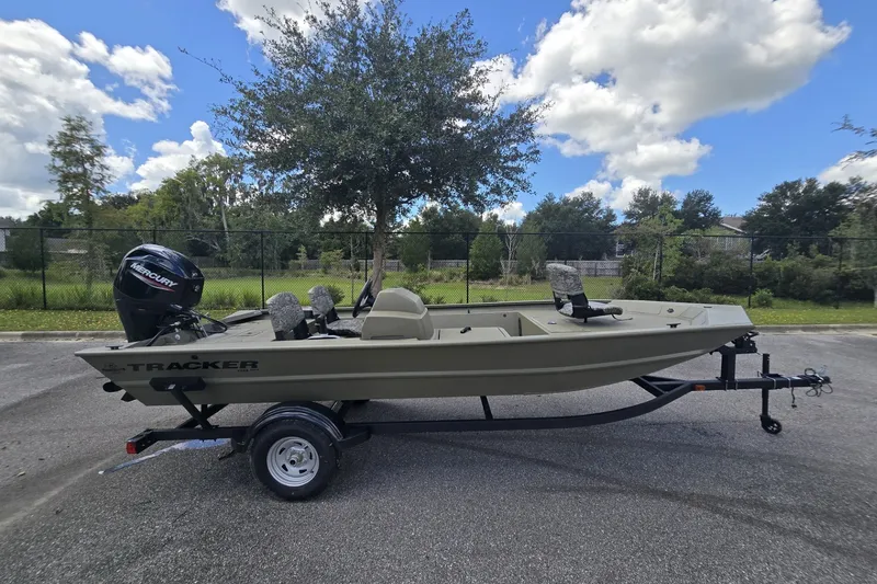 The Image of 2026 Tracker Grizzly 1754 SC boat on trailer, parked outdoors under a cloudy sky. - 0