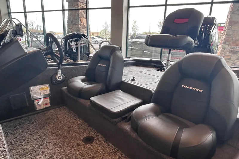 Slide: The Image of 2026 Tracker Pro Team 195 boat interior with comfortable seating and Mercury engine. - 5