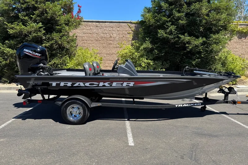 Slide: The Image of 2026 Tracker Pro Team 175 Crappie Edition boat on trailer, parked outdoors. - 5