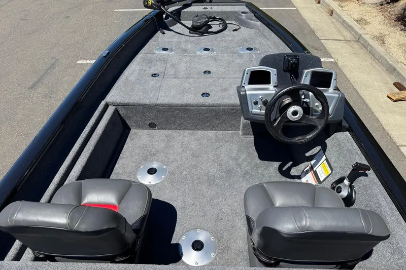 Slide: The Image of 2026 Tracker Pro Team 175 Crappie Edition boat interior with steering console and seating. - 13