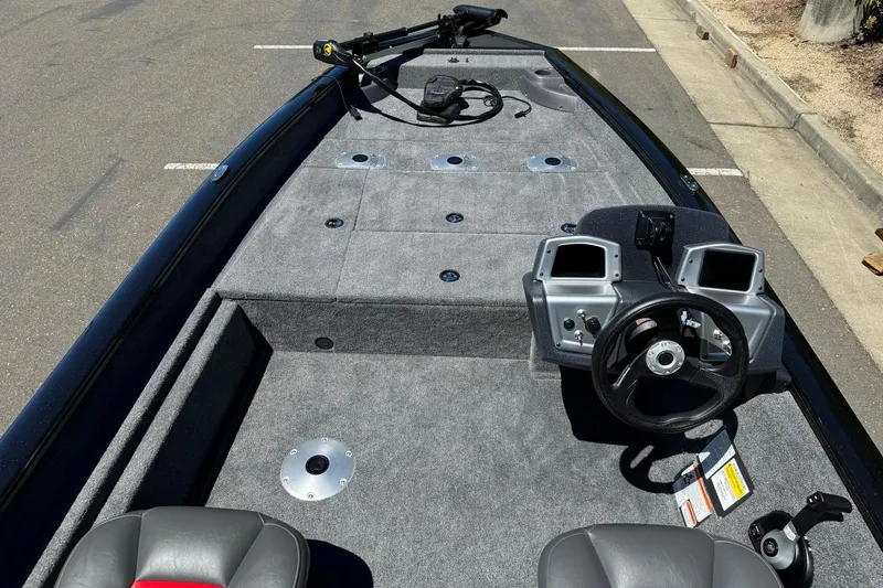 Slide: The Image of 2026 Tracker Pro Team 175 Crappie Edition boat interior with steering console and seating. - 9