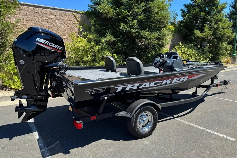 Slide: The Image of 2026 Tracker Pro Team 175 Crappie Edition boat with Mercury engine in parking lot. - 6