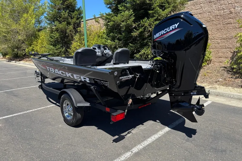 Slide: The Image of 2026 Tracker Pro Team 175 Crappie Edition boat with Mercury engine in parking lot. - 7