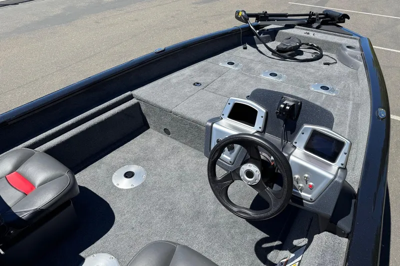 Slide: The Image of 2026 Tracker Pro Team 175 Crappie Edition boat interior with steering wheel and seating. - 14