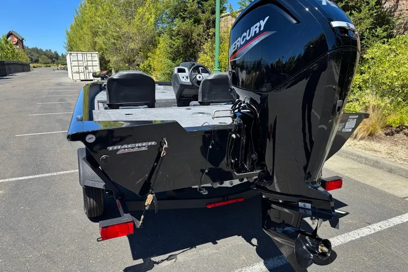 Slide: The Image of 2026 Tracker Pro Team 175 Crappie Edition boat with Mercury engine in parking lot. - 2