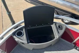 Slide: The Image of 2026 Sun Tracker Bass Buggy 18 DLX boat storage compartment with cup holders. - 15