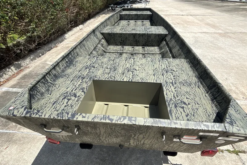 Slide: The Image of 2026 Tracker Grizzly 15 Jon boat with camouflage design, parked outdoors. - 15