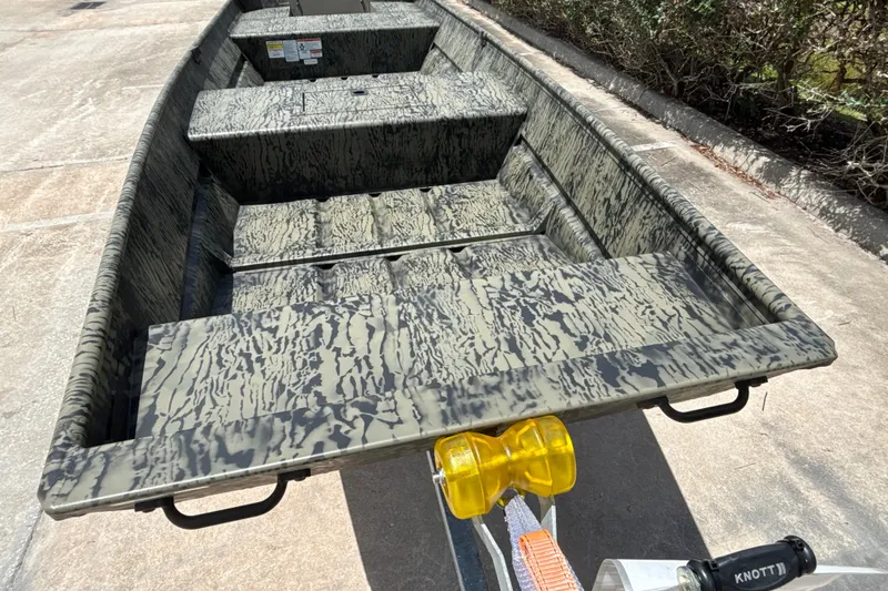 Slide: The Image of 2026 Tracker Grizzly 15 Jon boat with camouflage pattern on a trailer. - 14