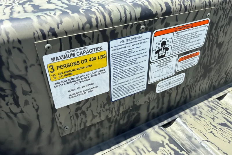 Slide: The Image of 2026 Tracker Grizzly 15 Jon boat safety labels detailing capacity and warnings. - 16