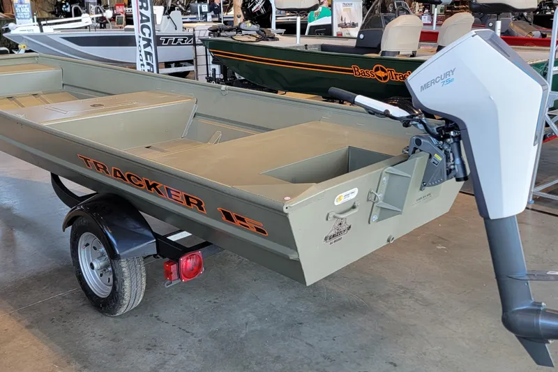 The Image of 2026 Tracker Grizzly 15 Jon boat with Mercury engine on display in showroom. - 0