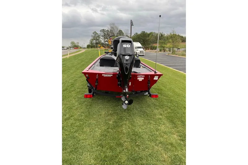 Slide: The Image of 2026 Tracker Pro 170 boat with 50 HP motor on grassy area. - 11