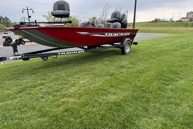 Slide: The Image of 2026 Tracker Pro 170 boat on trailer, parked on grassy area. - 2