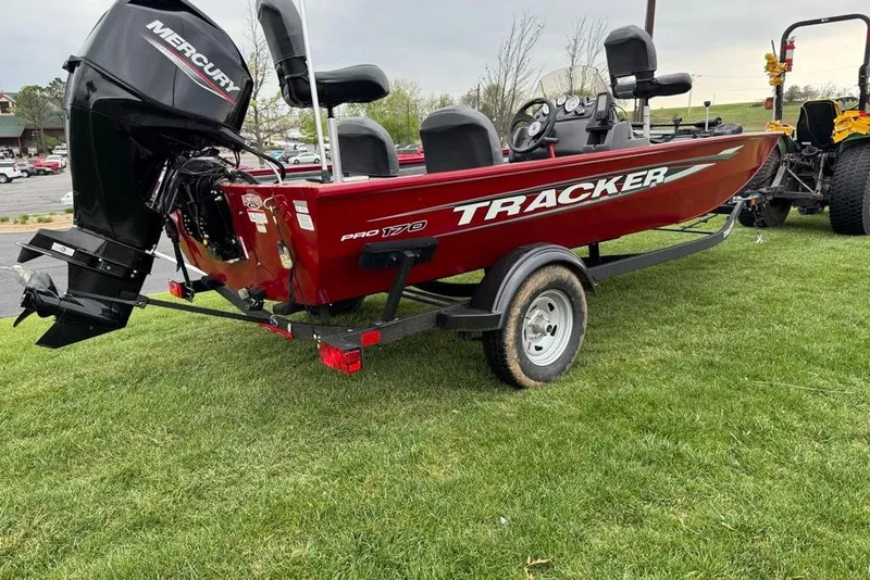 Slide: The Image of 2026 Tracker Pro 170 boat with Mercury engine on grassy area. - 3