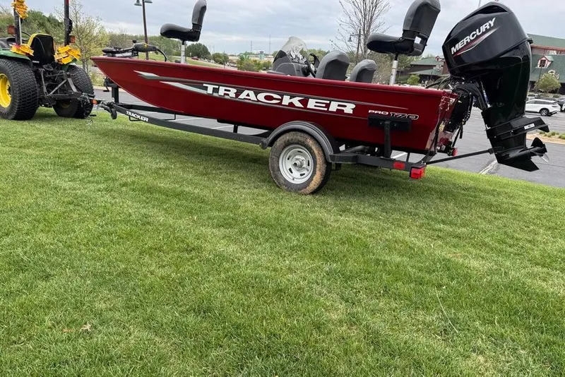 Slide: The Image of 2026 Tracker Pro 170 boat on trailer, parked on grass, with Mercury outboard motor. - 4
