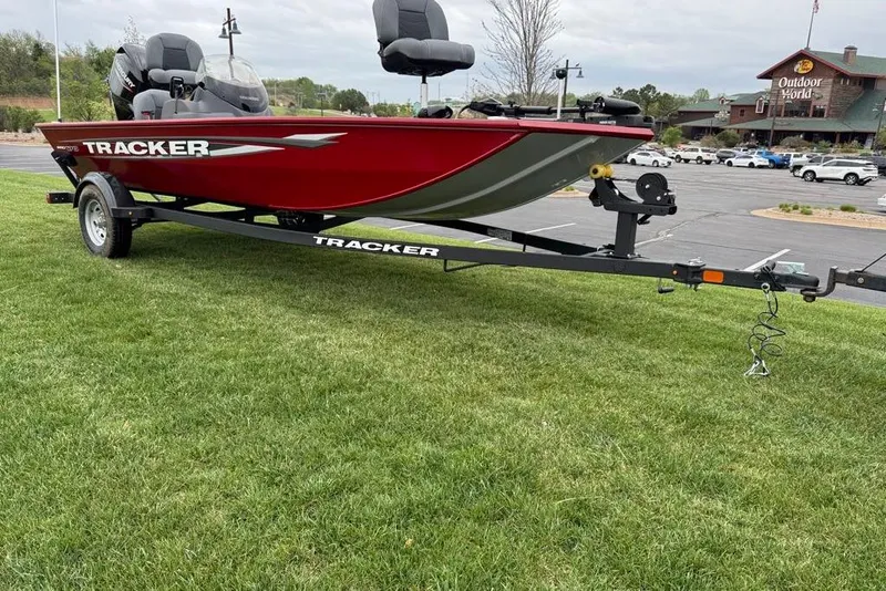 Slide: The Image of 2026 Tracker Pro 170 boat on trailer, parked on grass near Outdoor World. - 5